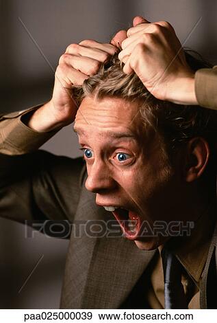 Man with mouth and eyes wide open, pulling hair, close-up View Large Photo Image Stock Photo - Man with mouth and eyes wide open, pulling hair, close-up. Fotosearch