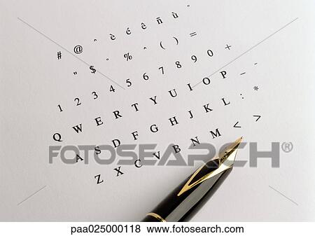 Stock Photo - Numbers and alphabet printed on paper, tip of fountain pen. Fotosearch