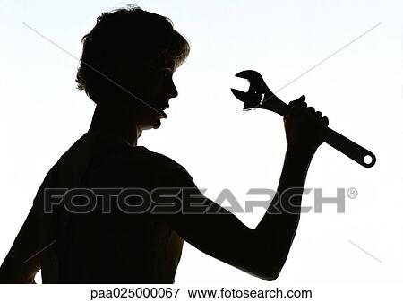 Woman holding wrench, silhouette View Large Photo Image Stock Photo - Woman holding wrench, silhouette. Fotosearch