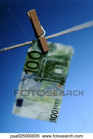 Stock Photography - Wrinkled hundred euro bill hanging on clothesline with clothes peg. Fotosearch