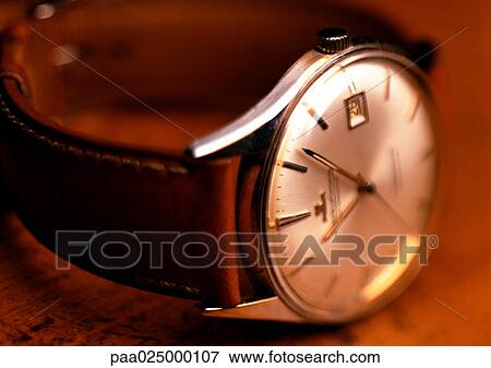 Wristwatch with white face and leather band, wood background, close-up View Large Photo Image Stock Photo - Wristwatch with white face and leather band, wood background, close-up. Fotosearch