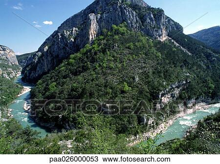 Stock Image - France, Provence, Verdon River winding around a mountain. Fotosearch