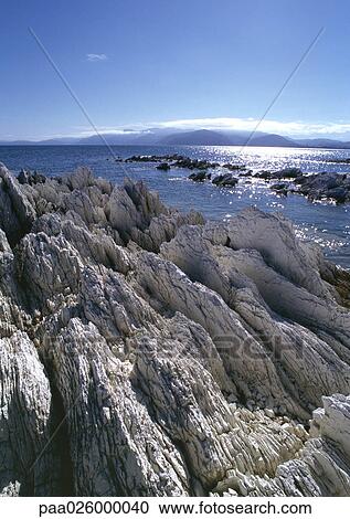 Stock Image - New Zealand, rocky shoreline and sea. Fotosearch