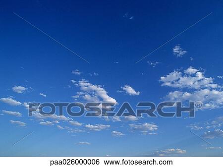 Sparse clouds in blue sky. View Large Photo Image Stock Photograph - Sparse clouds in blue sky.. Fotosearch