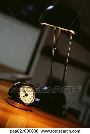 Alarm clock and desk lamp on desk View Large Photo Image Stock Photo - Alarm clock and desk lamp on desk. Fotosearch