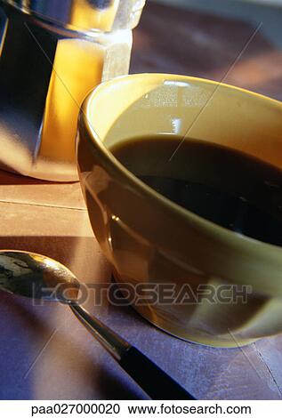 Bowl of coffee on table with spoon View Large Photo Image Stock Image - Bowl of coffee on table with spoon. Fotosearch