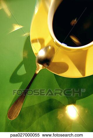Coffee in yellow cup and saucer with spoon on green background View Large Photo Image Stock Photography - Coffee in yellow cup and saucer with spoon on green background. Fotosearch