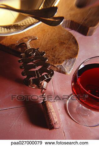 Corkscrew next to glass of wine View Large Photo Image Stock Photo - Corkscrew next to glass of wine. Fotosearch