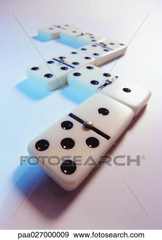 Stock Photo - Dominoes on white surface, close-up. Fotosearch