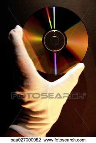 Gloved hand holding CD, close-up View Large Photo Image Stock Image - Gloved hand holding CD, close-up. Fotosearch