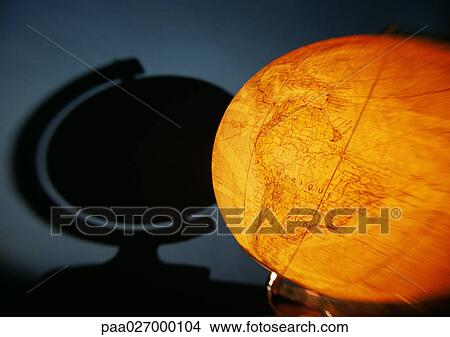 Picture - Illuminated globe and shadow on wall. Fotosearch