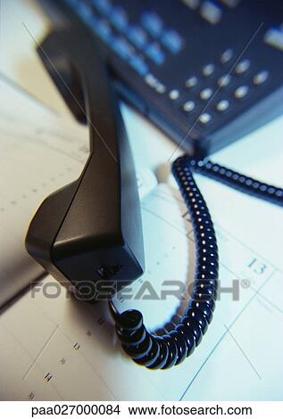 Phone off hook, on open agenda, close-up View Large Photo Image Picture - Phone off hook, on open agenda, close-up. Fotosearch