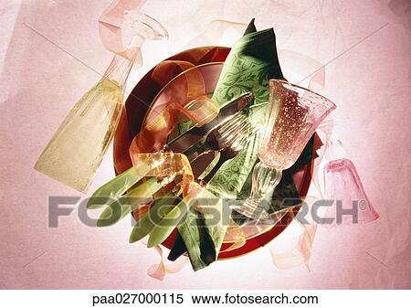 Silverware and napkins on stack of plates, with glasses, high angle view View Large Photo Image Stock Photography - Silverware and napkins on stack of plates, with glasses, high angle view. Fotosearch