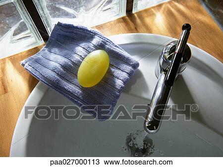 Soap and washcloth on edge of sink, high angle view View Large Photo Image Stock Image - Soap and washcloth on edge of sink, high angle view. Fotosearch