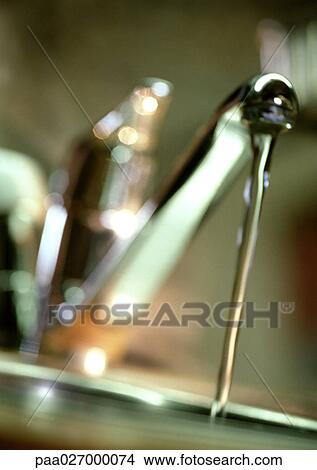 Water running from faucet, close-up, blurred View Large Photo Image Picture - Water running from faucet, close-up, blurred. Fotosearch