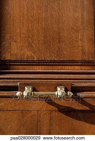 Stock Photo - Carved wood and brass handle.. Fotosearch