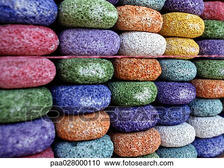 Stock Image - Stacks of round multi-colored pumice stones in rows.. Fotosearch
