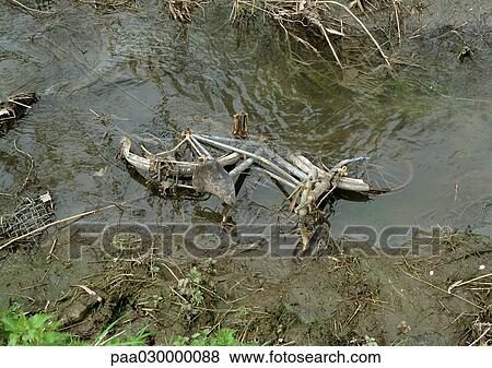 Bicycle submerged in mud and water. View Large Photo Image Stock Photo - Bicycle submerged in mud and water.. Fotosearch