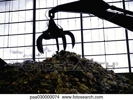 Claw-like machine picking up trash in warehouse. View Large Photo Image Picture - Claw-like machine picking up trash in warehouse.. Fotosearch