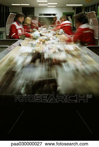 Stock Photo - People working in assembly line, blurred.. Fotosearch