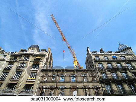 Picture - Building facades with crane, low angle view. Fotosearch