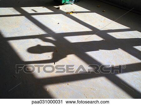 Stock Image - Construction worker's shadow. Fotosearch