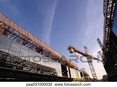 Stock Image - Crane in construction site, low angle view. Fotosearch