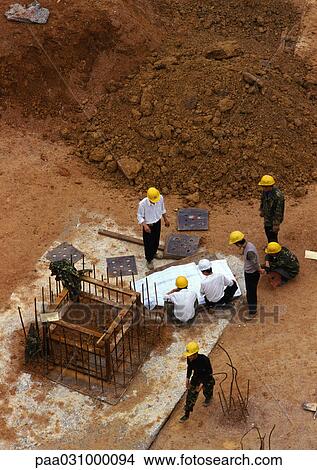 Picture - People wearing hard hats on construction site, elevated view. Fotosearch