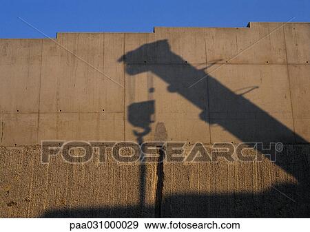 Shadow of crane projected onto wall View Large Photo Image Stock Photo - Shadow of crane projected onto wall. Fotosearch