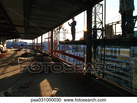 Stock Image - Two people in construction site. Fotosearch