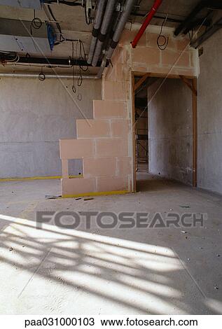 Stock Image - Unfinished wall in empty room. Fotosearch
