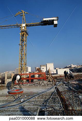 Stock Photo - Workers at construction site. Fotosearch