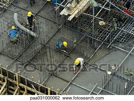 Workers in construction site, elevated view View Large Photo Image Stock Image - Workers in construction site, elevated view. Fotosearch