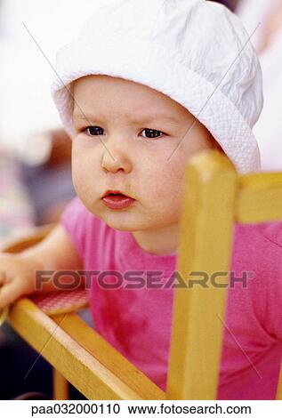 Stock Image - Baby wearing hat, portrait. Fotosearch