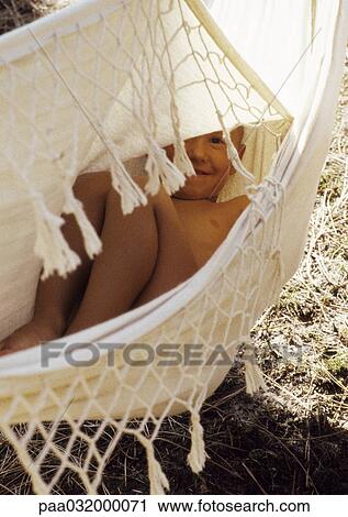 Child lying in hammock, smiling View Large Photo Image Stock Image - Child lying in hammock, smiling. Fotosearch