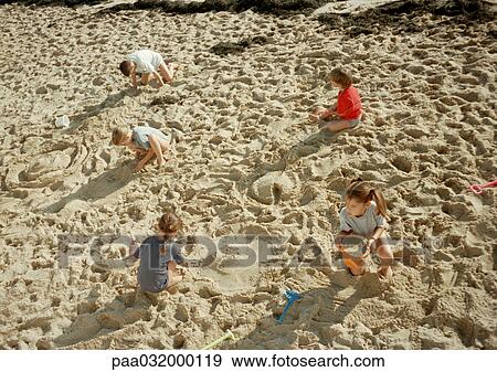 Children digging in sand, elevated view View Large Photo Image Stock Photo - Children digging in sand, elevated view. Fotosearch