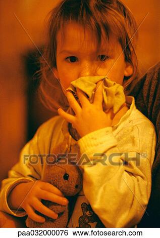 Stock Photograph - Girl hugging stuffed rabbit, portrait. Fotosearch