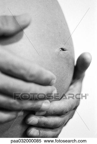 Hands on pregnant woman's belly, b&w View Large Photo Image Stock Photography - Hands on pregnant woman's belly, b&w. Fotosearch