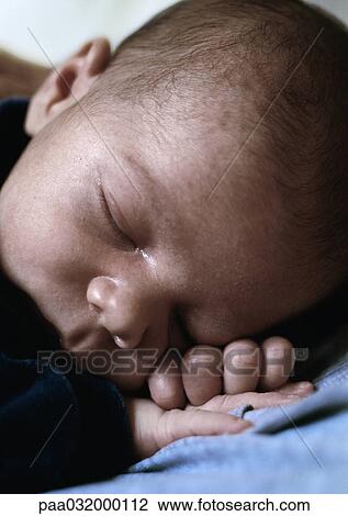 Stock Image - Infant sleeping, close-up. Fotosearch