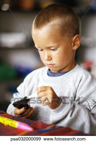 Little boy holding toy gun View Large Photo Image Stock Photo - Little boy holding toy gun. Fotosearch
