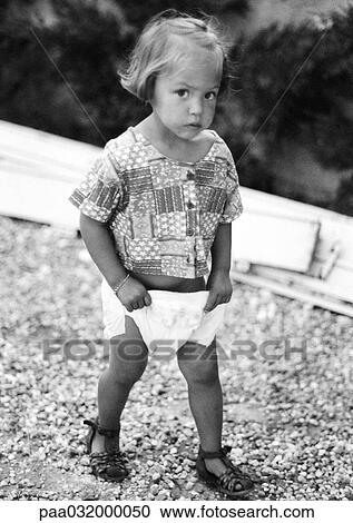 Stock Image - Little girl holding diaper, b&w. Fotosearch