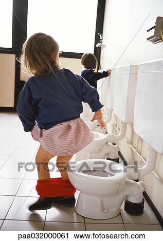 Little girl next to children's toilet with panties around ankles, rear view, other toilets and child in background. View Large Photo Image Stock Image - Little girl next to children's toilet with panties around ankles, rear view, other toilets and child in background.. Fotosearch