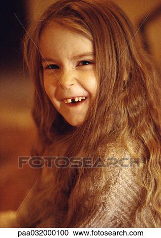 Stock Image - Little girl smiling with missing tooth. Fotosearch