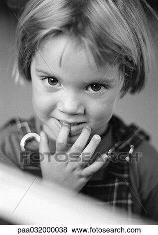 Little girl with finger in mouth, portrait, b&w View Large Photo Image Stock Photo - Little girl with finger in mouth, portrait, b&w. Fotosearch