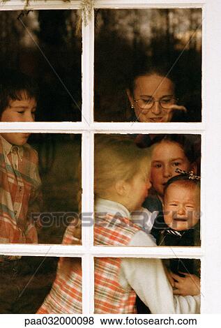 Mature woman and children behind window View Large Photo Image Stock Photo - Mature woman and children behind window. Fotosearch