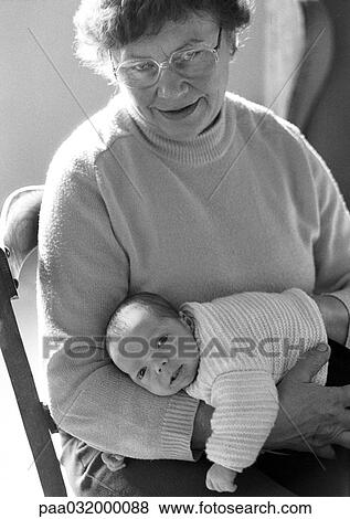 Stock Photo - Mature woman holding baby, b&w. Fotosearch