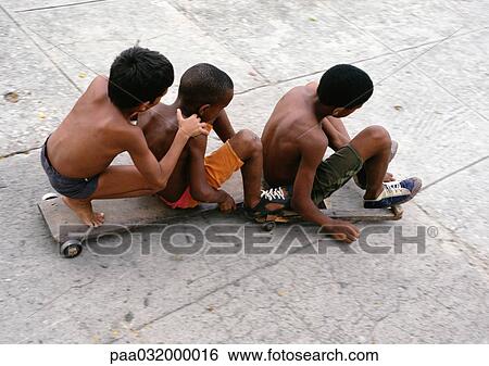 Three boys sitting on skateboards, elevated view View Large Photo Image Stock Photograph - Three boys sitting on skateboards, elevated view. Fotosearch