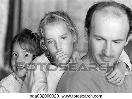 Two girls with father, b&w View Large Photo Image Stock Image - Two girls with father, b&w. Fotosearch