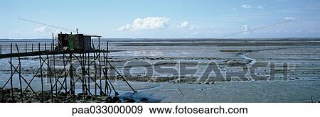 Stock Photo - France, seashore at low tide, panoramic view. Fotosearch
