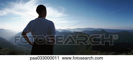 France, woman looking out over mountains at sunrise, rear view, panorama View Large Photo Image Stock Image - France, woman looking out over mountains at sunrise, rear view, panorama. Fotosearch